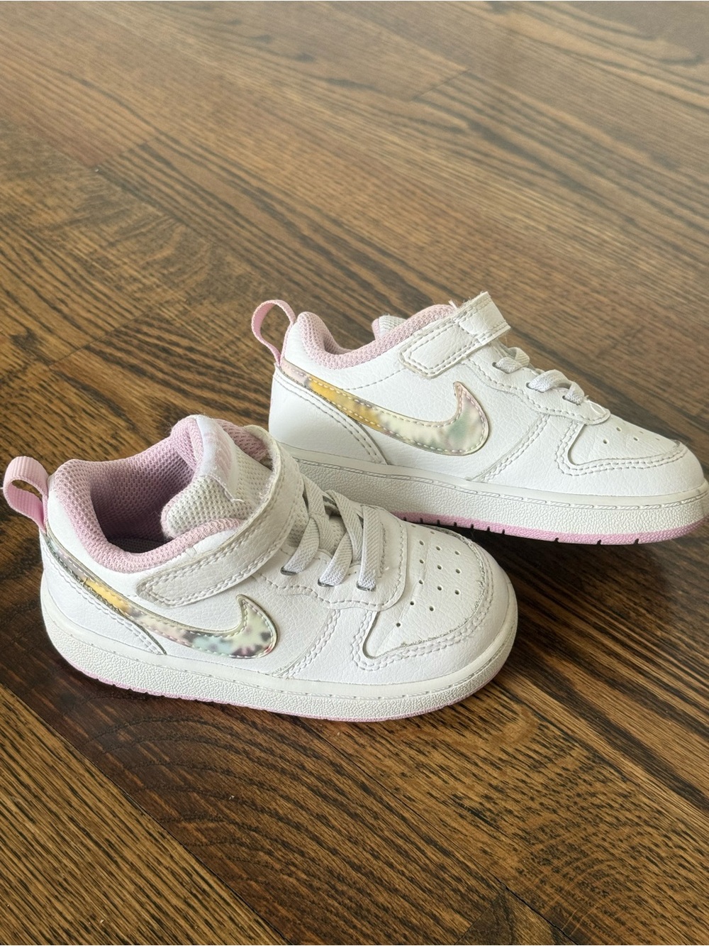 Nike Kids White Sneakers with Pink Trim and Holographic Swoosh